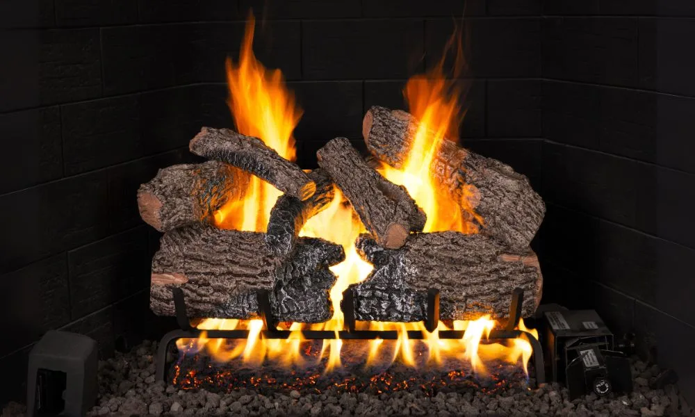 A Real Fyre charred oak gas log set burning in a masonry firebox
