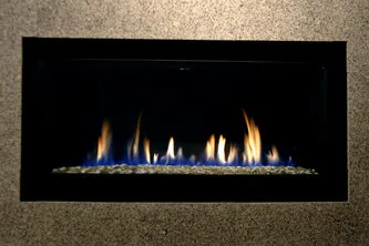 A Montigo linear gas fireplace burning on the showroom floor