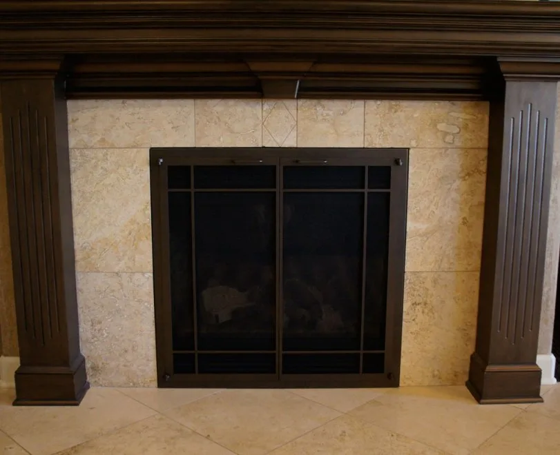 The same fireplace after its renewal with new glass doors and finish, from our project gallery